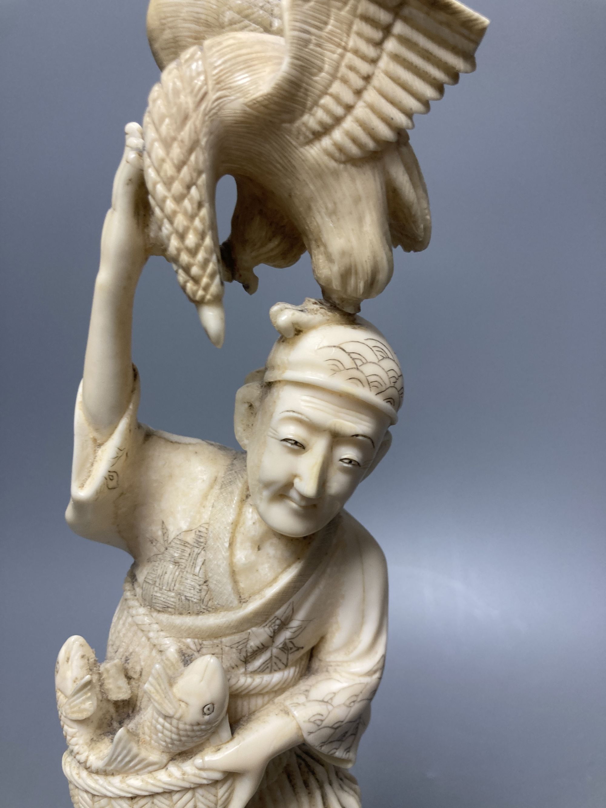 A Japanese walrus ivory okimono of a fisherman and boy, height 30cm